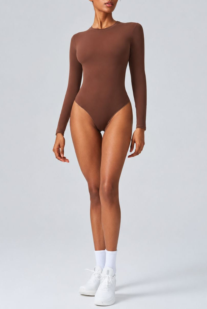 Woman wearing Aether Sculpting Long Sleeve Bodysuit in coffee, shown in a front pose with a sculpting fit.