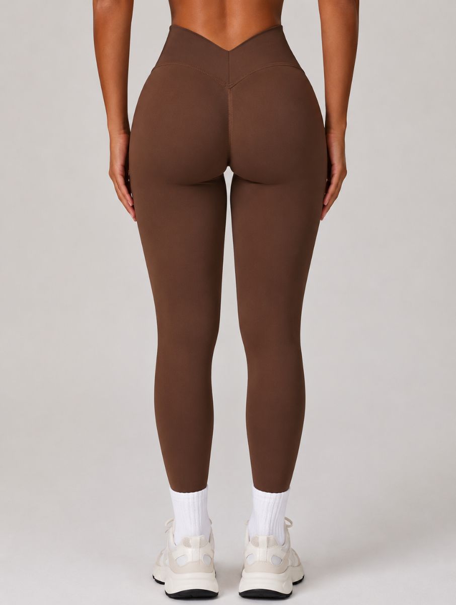 Woman wearing the ContourFlex Seamless Top & Leggings in Dark Coffee, standing in a back-facing pose with legs straight and arms relaxed at her sides.