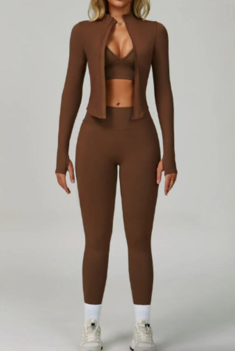 Model wearing the Dark Coffee ContourFlex Three-Piece Set with top, jacket and leggings in a front-facing pose with the jacket open.