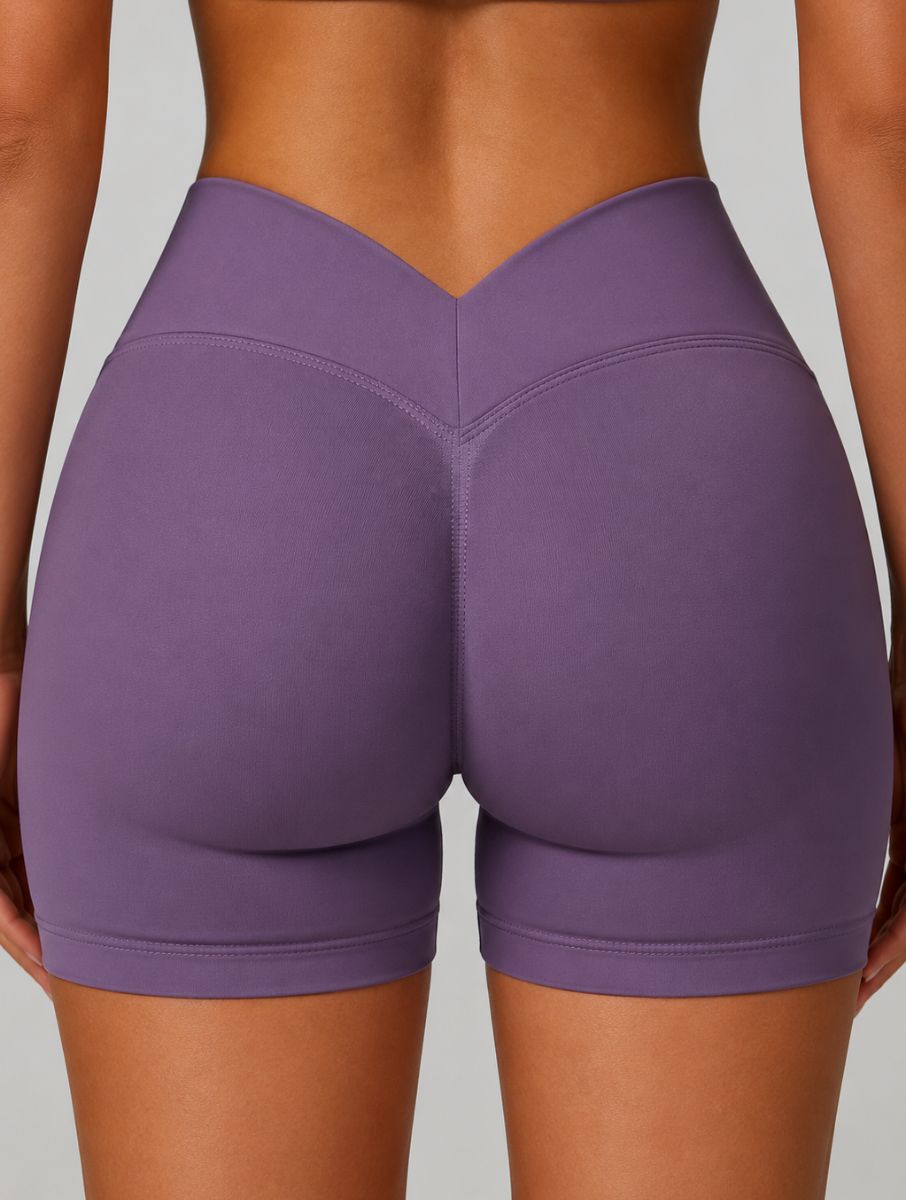 Front view of a woman wearing the ContourFlex Three-Piece Set in purple, featuring a fully zipped fitted jacket, standing with her arms at her sides.