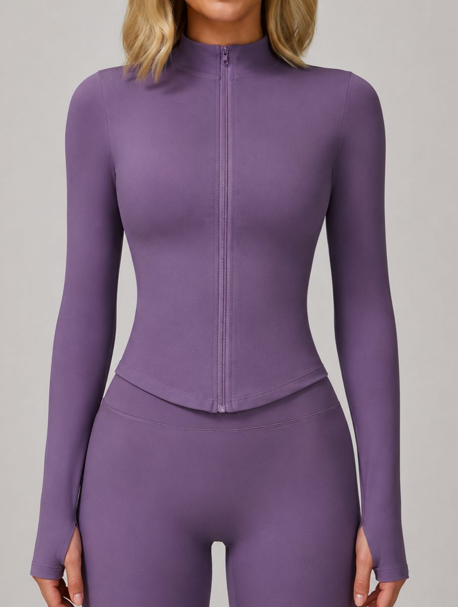 Front view of a woman wearing the ContourFlex Three-Piece Set in purple, featuring a fully zipped fitted jacket, standing with her arms at her sides.