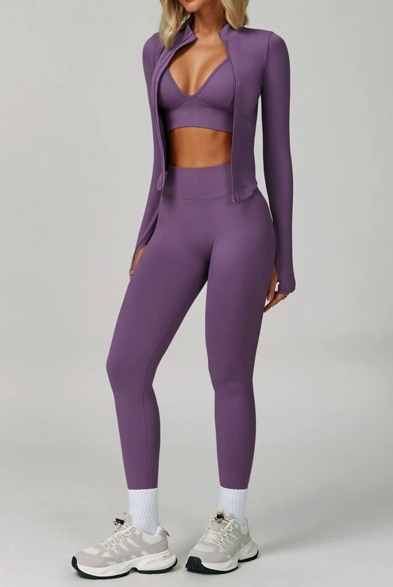 Model wearing the Purple ContourFlex Three-Piece Set with top, jacket and leggings in a standing pose with the jacket open.