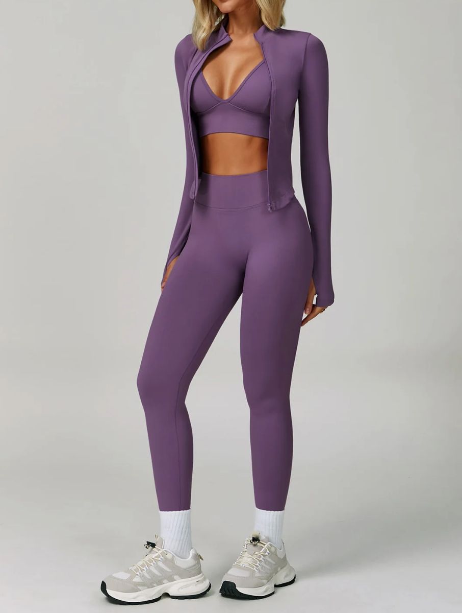 Model wearing the Purple ContourFlex Three-Piece Set with top, jacket and leggings in a standing pose with the jacket open.
