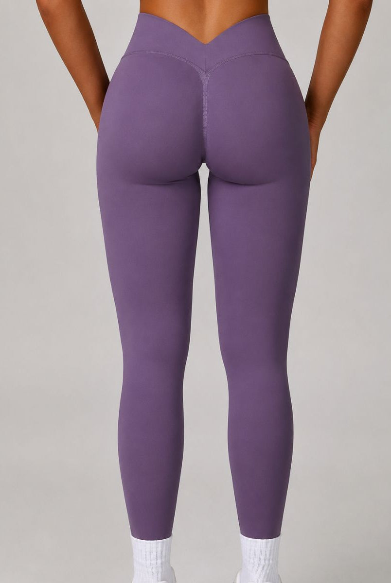 Model wearing the Purple ContourFlex Three-Piece Set with top, jacket and leggings in a standing pose with the jacket open.