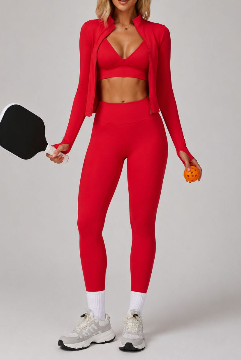 Model wearing the Red ContourFlex Three-Piece Set with top, jacket and leggings in a sporty standing pose.
