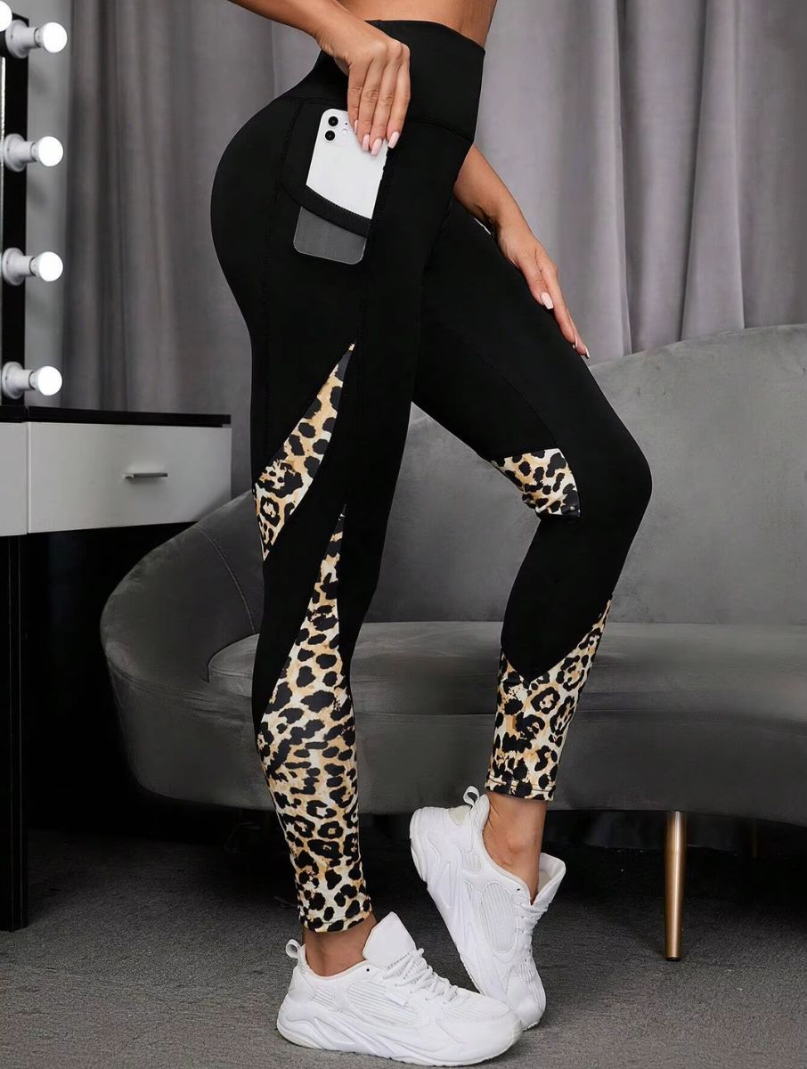 Savelle Leopard Contour Leggings in black with leopard pattern, shown in a side pocket pose with contour panel detailing.