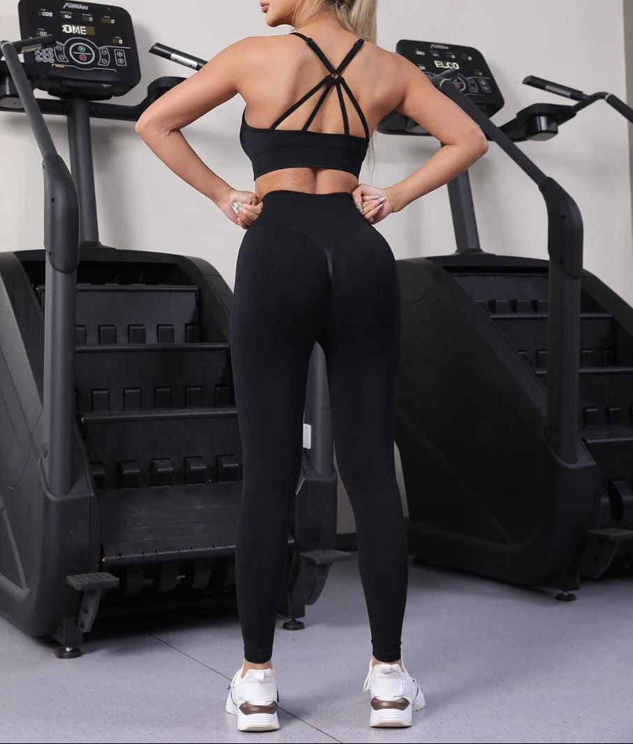 Woman wearing Seamless Hip-Lifting Yoga Set in black, shown in a back pose with a sculpting fit.