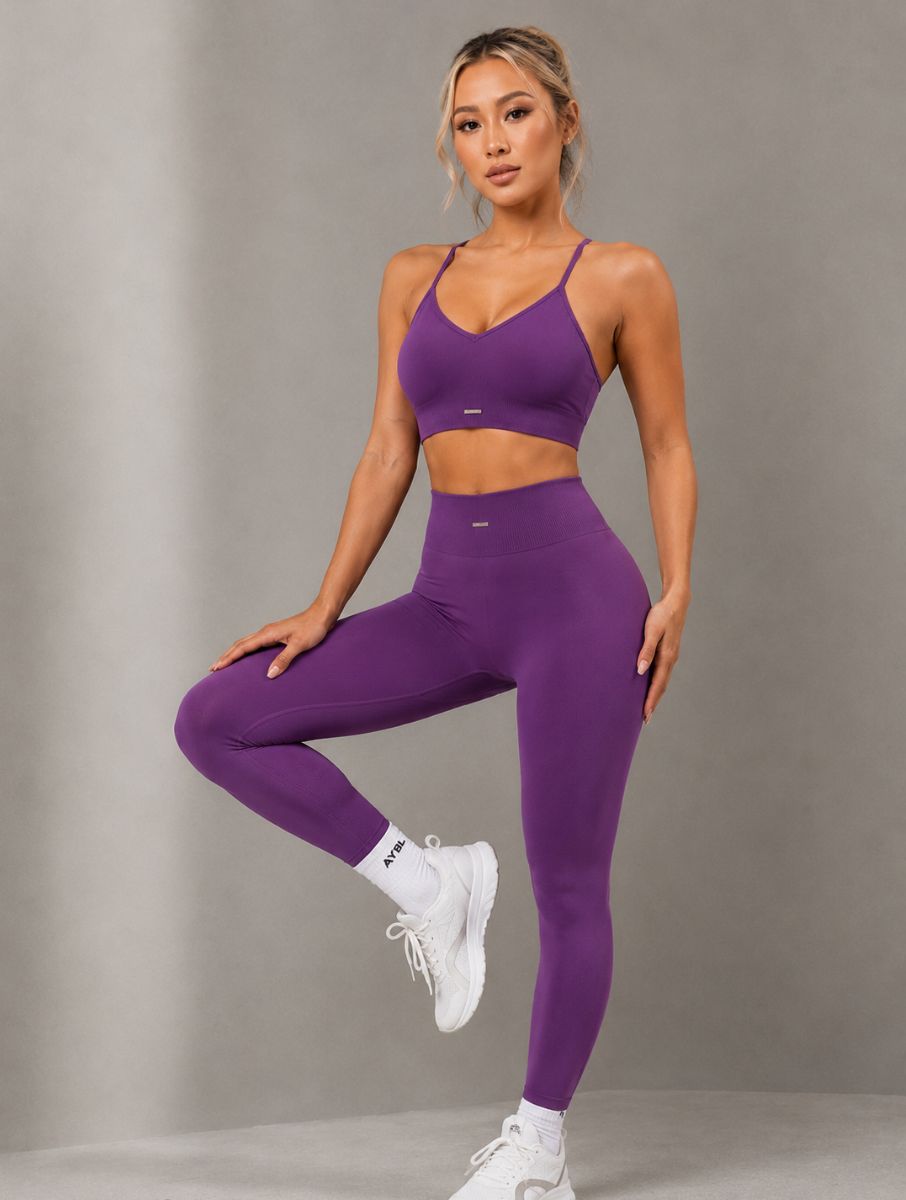 Woman wearing Seamless Hip-Lifting Yoga Set in purple, shown in a front pose with a sculpting fit.