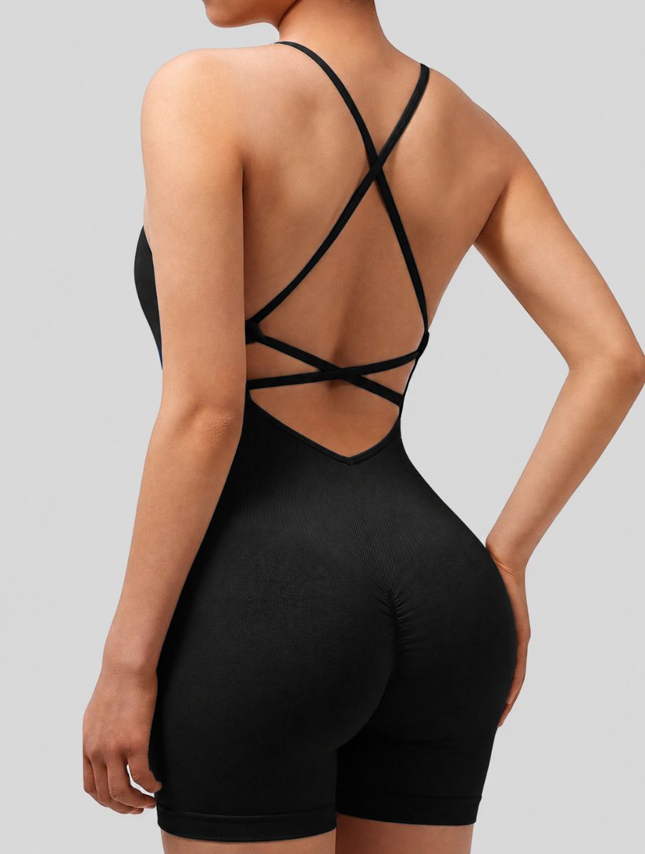 Veloura Seamless Sculpt Jumpsuit in black, shown in an open-back pose with criss-cross straps.