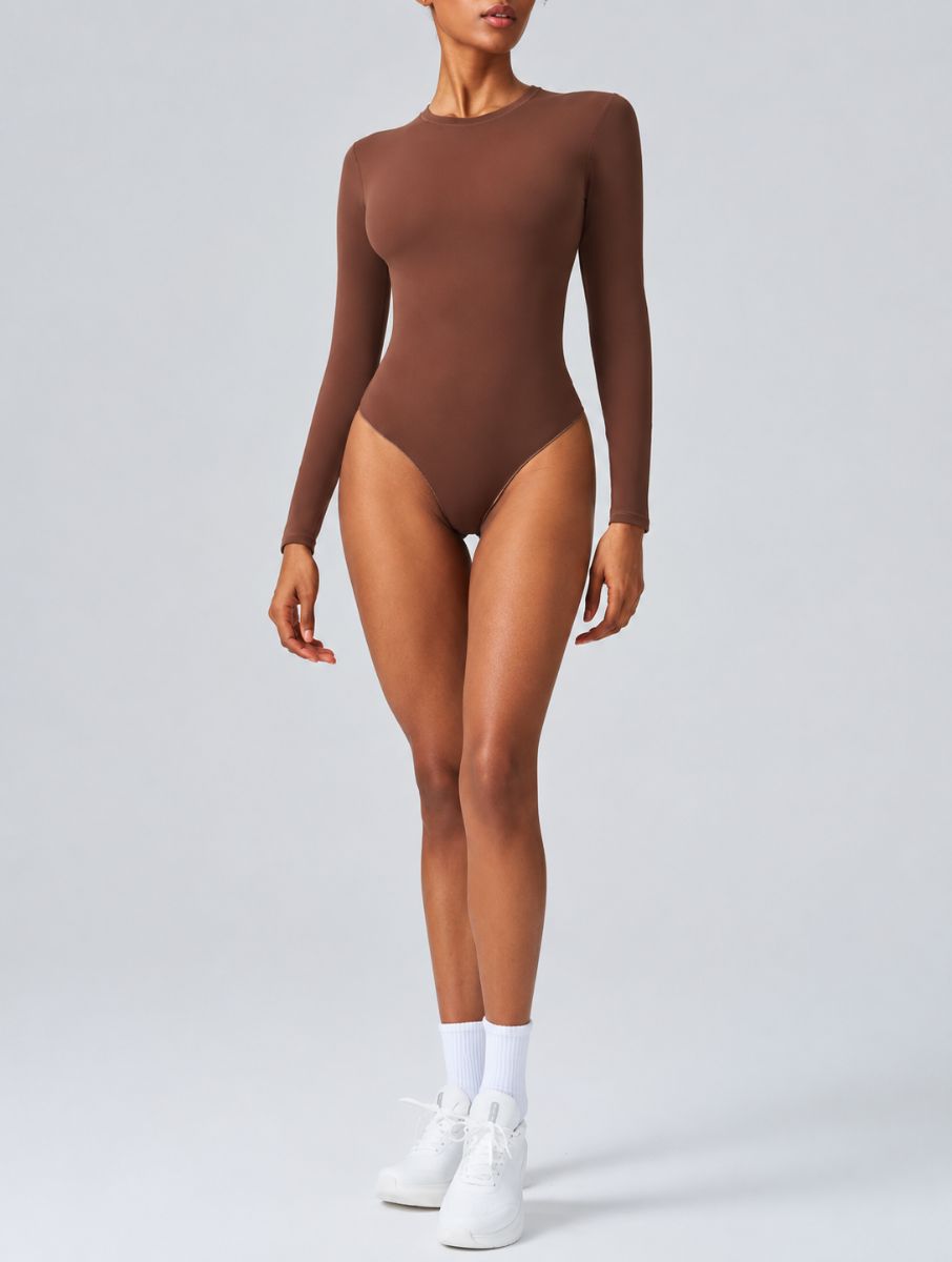 Woman wearing Aether Sculpting Long Sleeve Bodysuit in coffee, shown in a front pose with a sculpting fit.