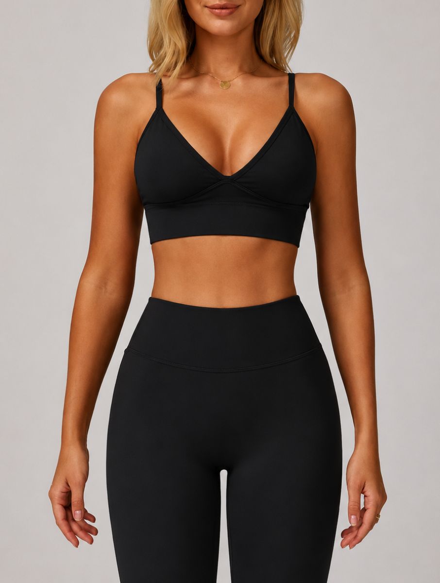 Woman wearing the ContourFlex Seamless Top & Leggings in Black, standing in a front-facing pose with arms relaxed at her sides.