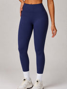 Woman wearing the ContourFlex Seamless Leggings in Navy Blue, shown in a front-facing pose highlighting the leggings fit.