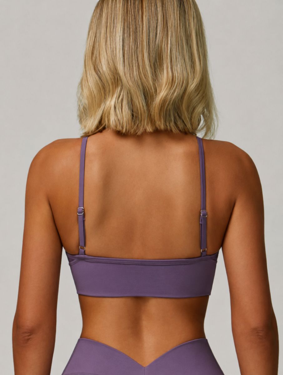 Woman wearing the ContourFlex Seamless Top in Purple, shown from the back in a standing pose highlighting the top design.