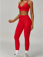 Woman wearing the ContourFlex Seamless Top & Leggings in Red, standing in a three-quarter pose with one arm relaxed at her side.