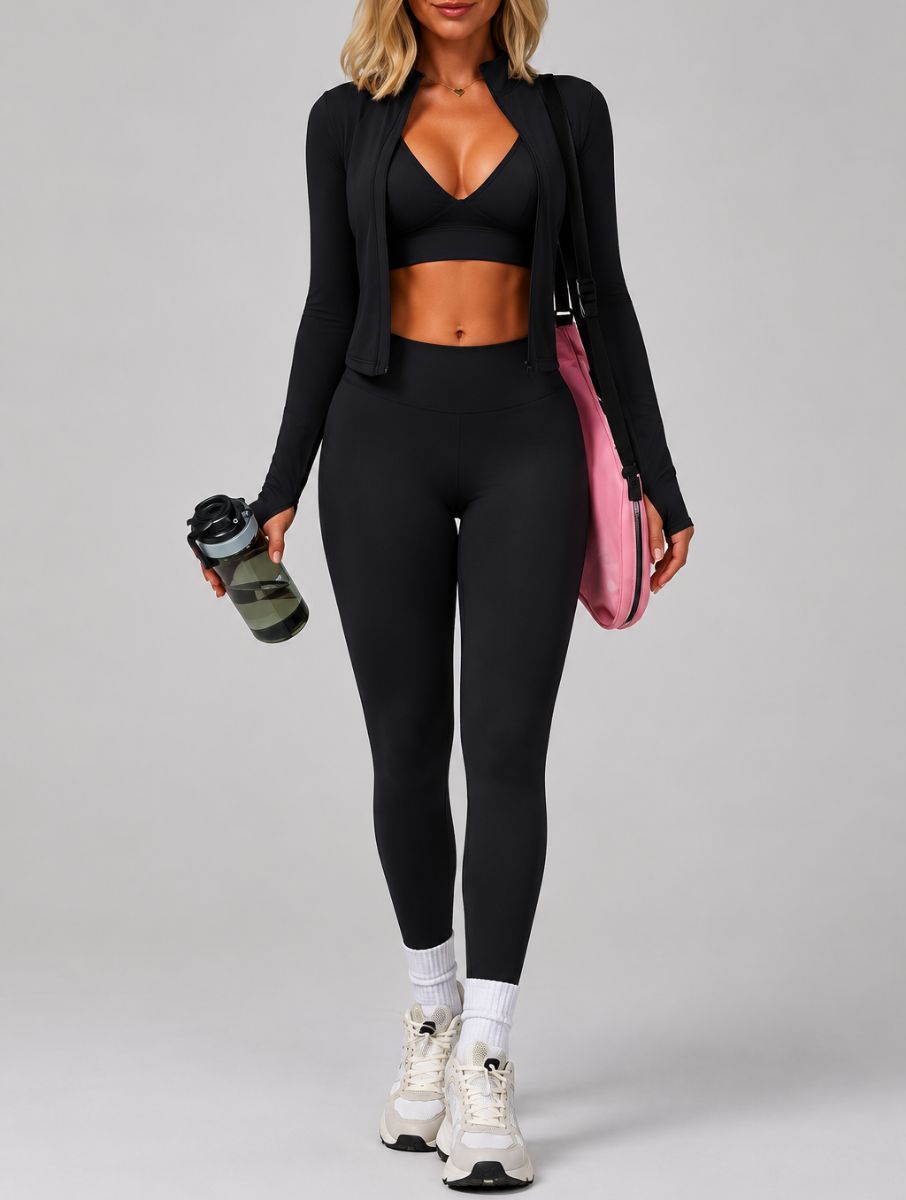 Model wearing the Black ContourFlex Three-Piece Set with top, jacket and leggings in a back three-quarter pose.