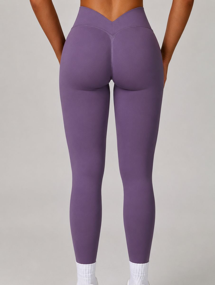 Model wearing the Purple ContourFlex Three-Piece Set with top, jacket and leggings in a standing pose with the jacket open.