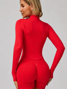 Back view of a woman wearing the ContourFlex Three-Piece Set in red, featuring a fitted jacket and shorts, posing with her hands by her sides while looking over her shoulder.