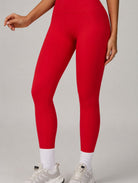 Red ContourFlex leggings shown in a front-detail pose, highlighting the smooth, sculpting fit.