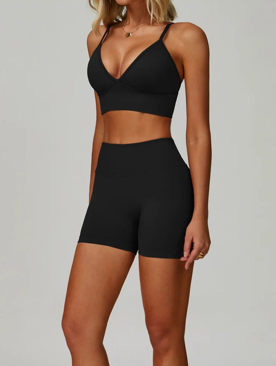 Woman wearing the ContourFlex Seamless Top & Shorts in Black, posing in a front-angle stance with a relaxed posture.