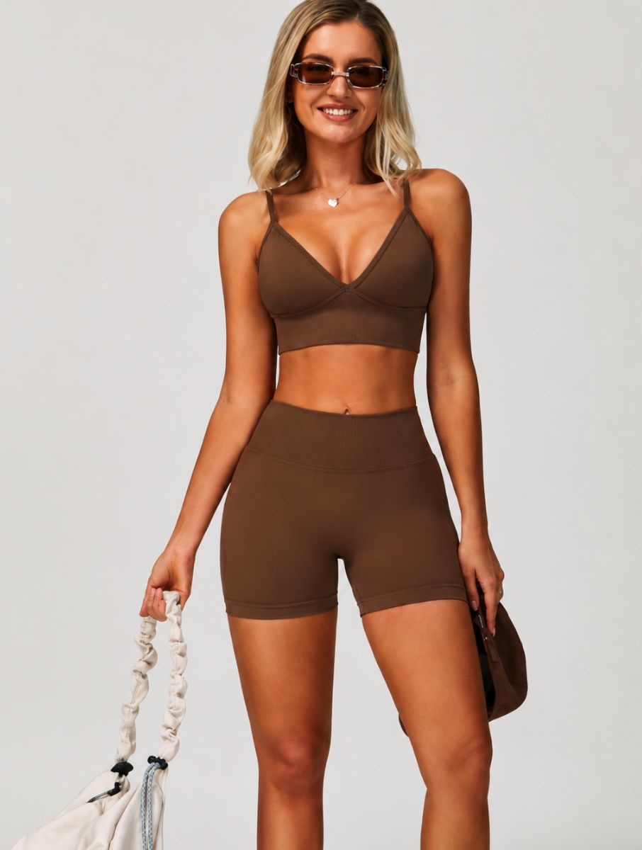 Woman wearing the ContourFlex Seamless Top & Short in Dark Coffee, standing in a relaxed front pose with sunglasses and a handbag.
