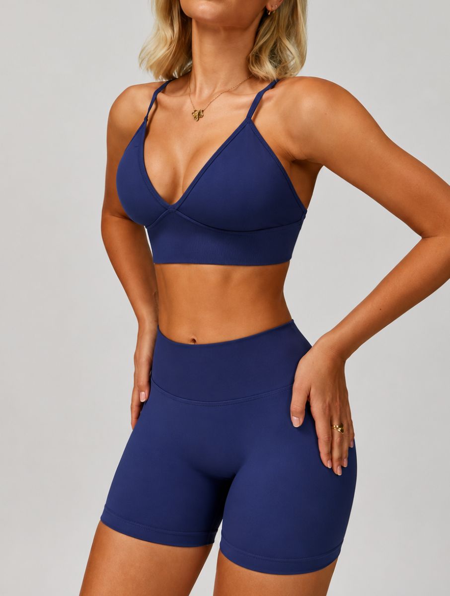 Woman wearing the ContourFlex Seamless Top & Shorts in Navy Blue, posing in a front-angle stance with hands on her hips.
