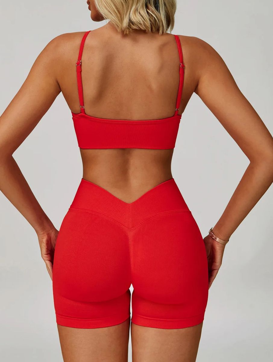 Woman wearing the ContourFlex Seamless Top & Shorts in Red, standing in a back-facing pose showcasing the seamless design.