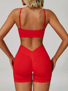Woman wearing the ContourFlex Seamless Top & Shorts in Red, standing in a back-facing pose showcasing the seamless design.