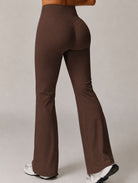 Woman wearing High-Waist Flared Yoga Leggings in brown, shown in a back pose with a flared-leg design.