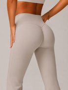 High-Waist Flared Yoga Leggings in grey apricot, shown in a back close-up shot with a flared-leg design.