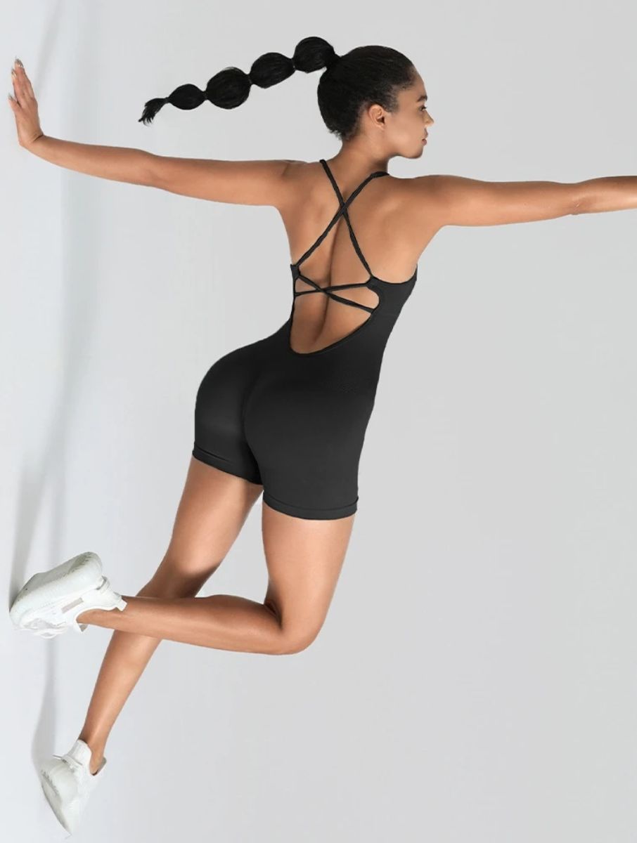 Veloura Seamless Sculpt Jumpsuit in black, shown in an action pose with an open-back design.