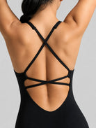 Veloura Seamless Sculpt Jumpsuit in black, shown in an open-back pose with criss-cross straps.