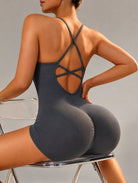 Veloura Seamless Sculpt Jumpsuit in dark grey, shown in a back pose with an open-back design.