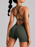 Veloura Seamless Sculpt Jumpsuit in green, shown in an open-back pose with criss-cross straps.