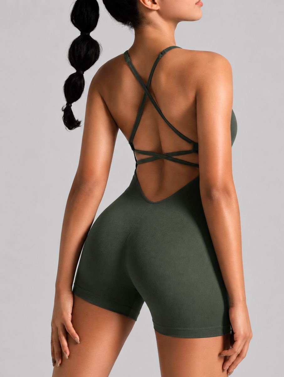 Veloura Seamless Sculpt Jumpsuit in green, shown in an open-back pose with criss-cross straps.